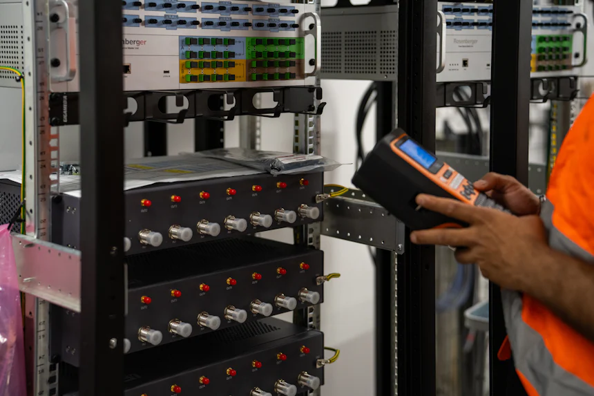 Technician testing server equipment with a handheld diagnostic tool