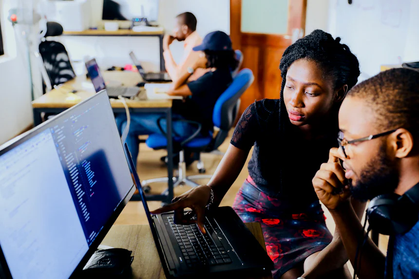 IT professionals collaborating at a workstation
