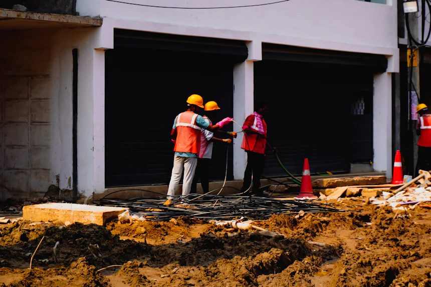 Site workers in hard hats and high-visibility vests