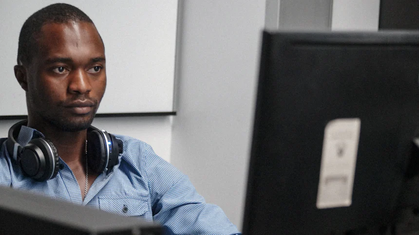 Engineer with a headset monitoring systems at a workstation